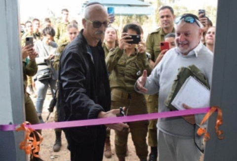 Graham Nussbaum, Chairman of Young Israel Synagogue, North Netanya, cuts the ribbon watched by Ian Fine, Chairman of the English-speaking branch of AWIS in Israel